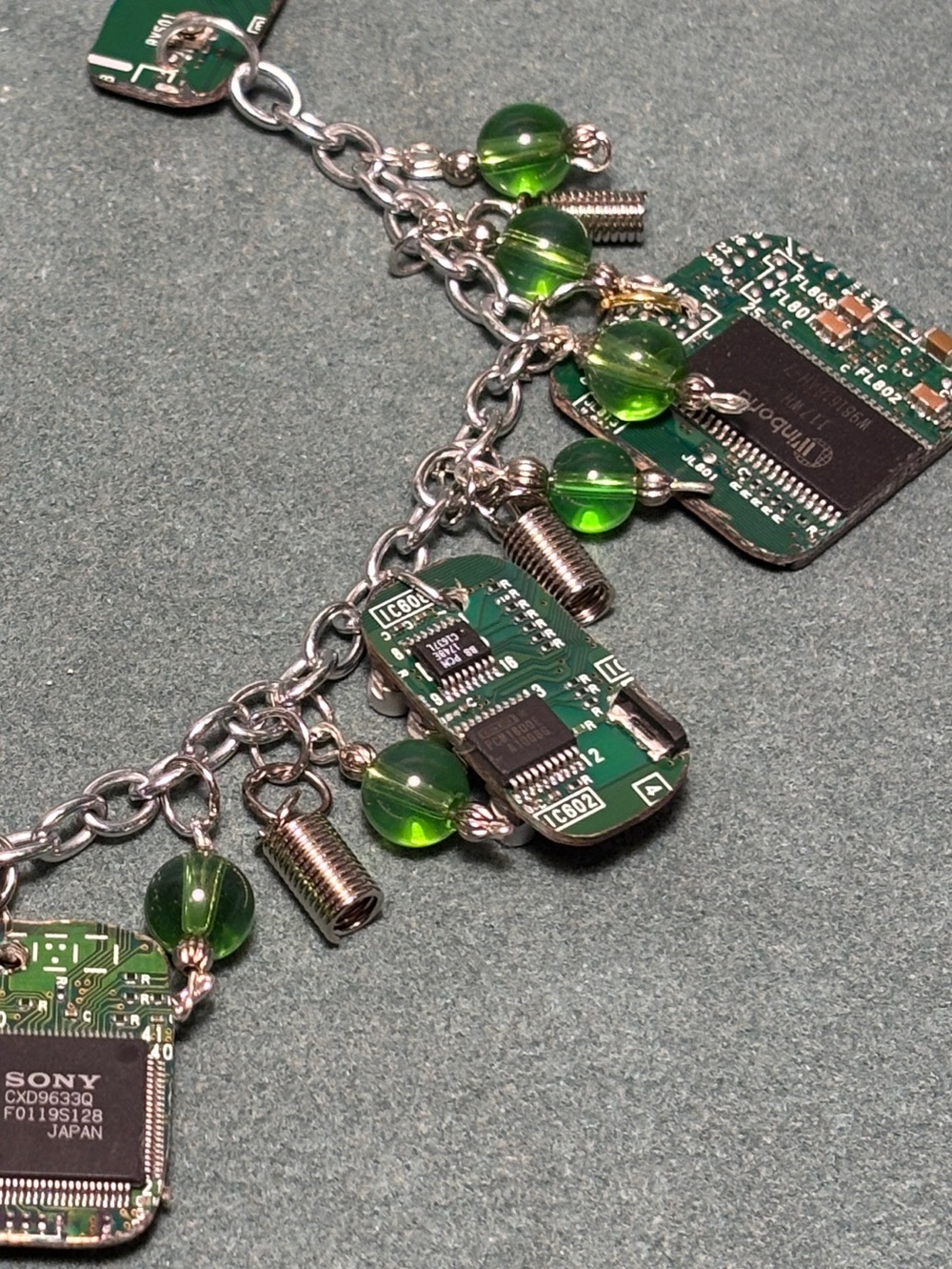 Unusual bracelet of repurposed computer guts and green beads